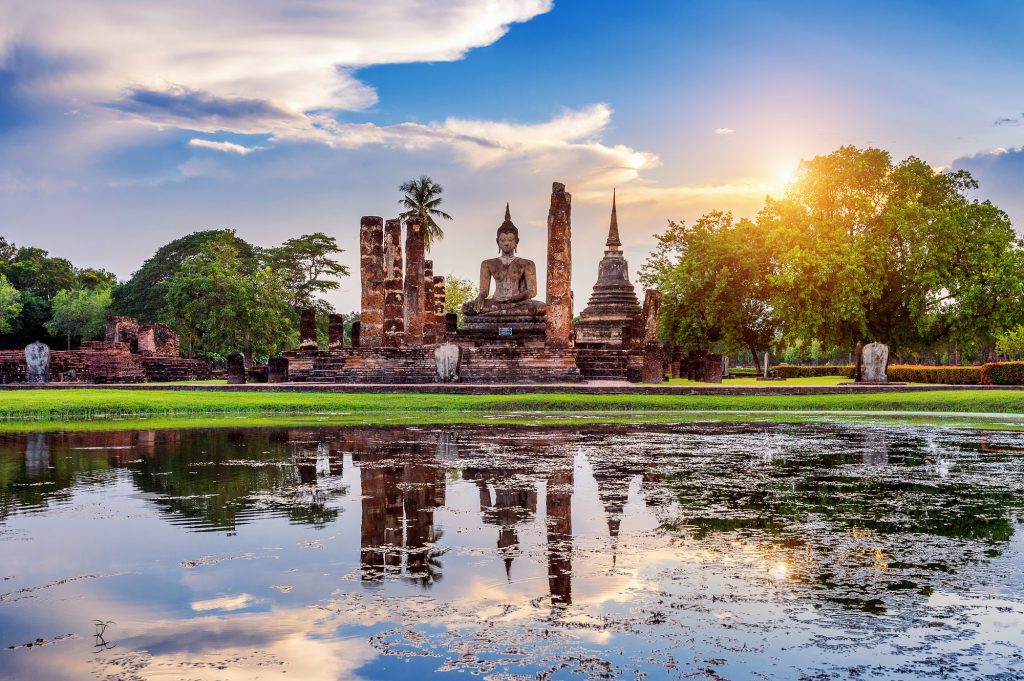 Buddha statue and Wat Mahathat Temple in the precinct of Sukhoth